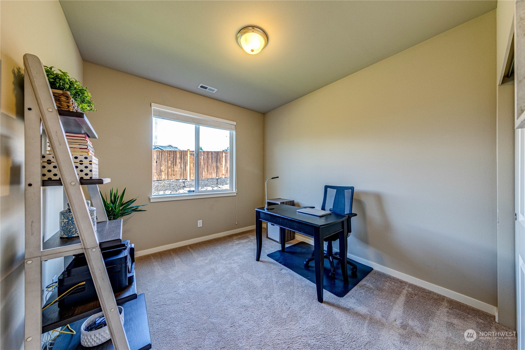 4315 229th Place Southeast Bothell, WA 98021 - Photo 21 of 40 a view of a workspace with furniture and a window