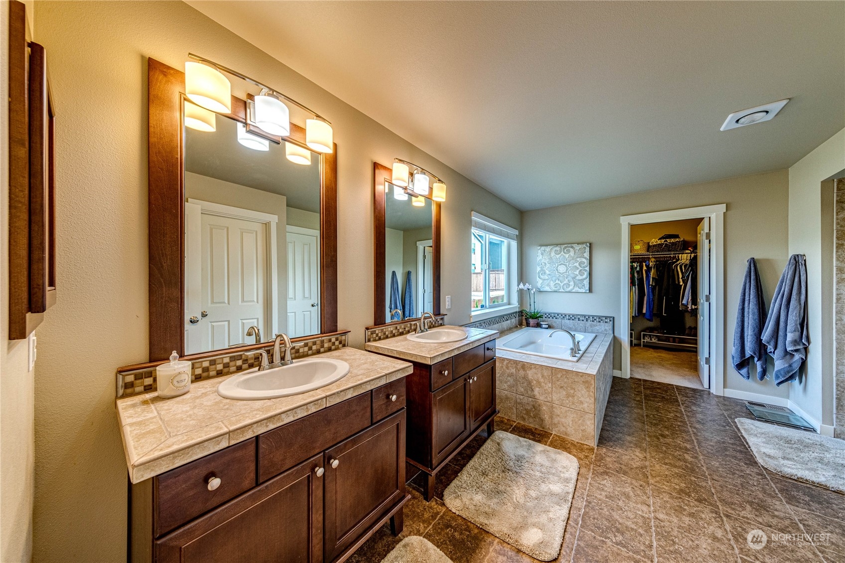 4315 229th Place Southeast Bothell, WA 98021 - Photo 25 of 40 a spacious bathroom with a granite countertop sink and a mirror