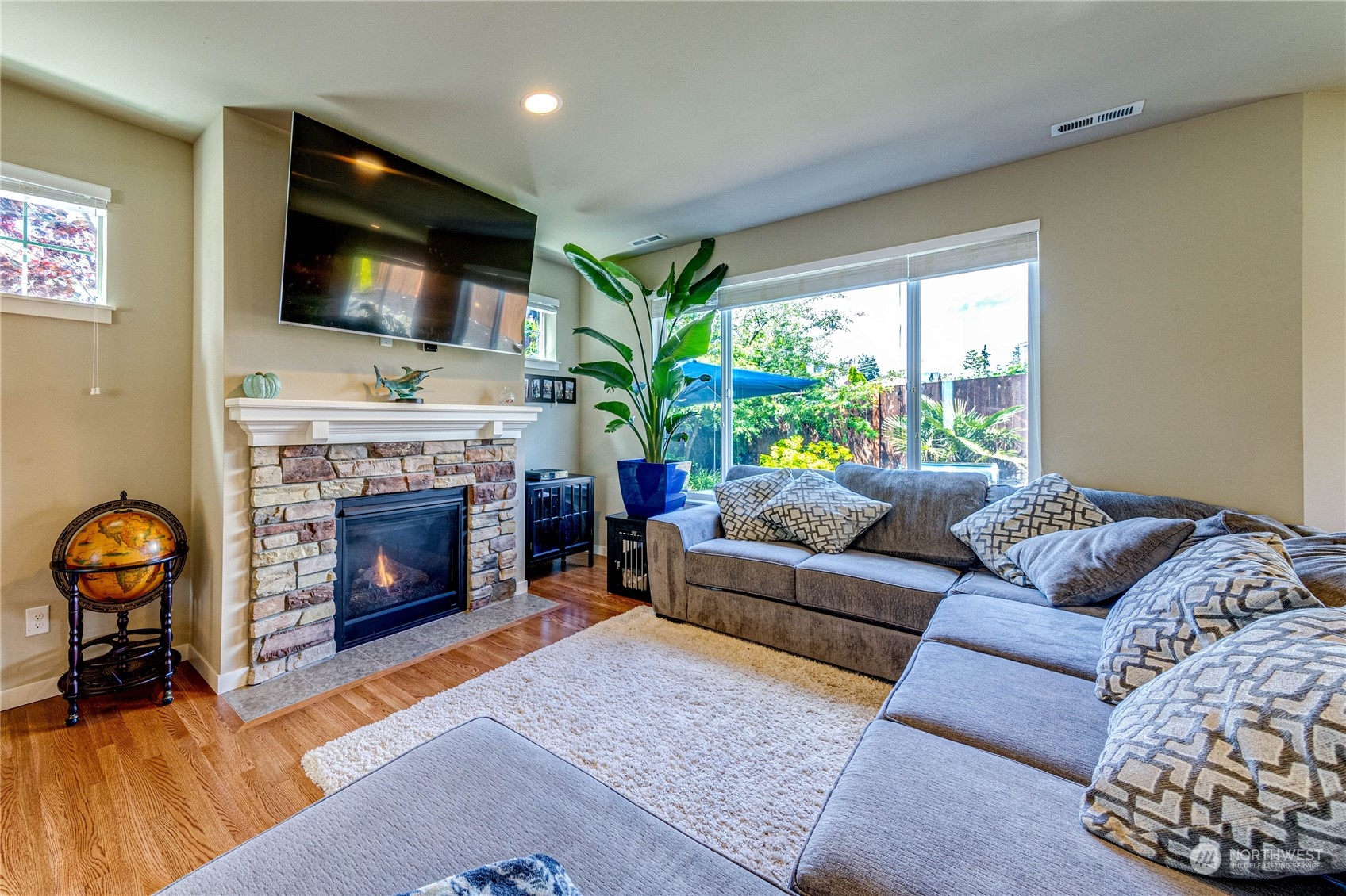 4315 229th Place Southeast Bothell, WA 98021 - Photo 10 of 40 a living room with furniture a flat screen tv and a fireplace