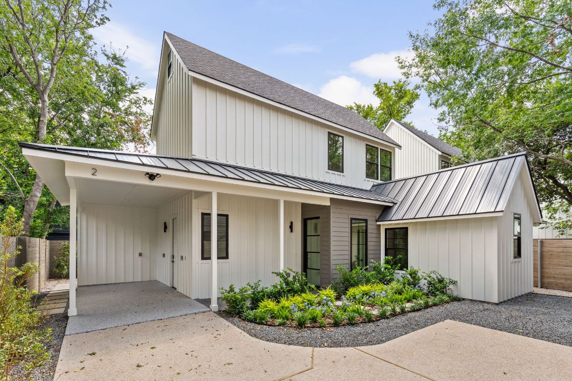 Modern farmhouse style home with board and batten siding, a porch, and driveway