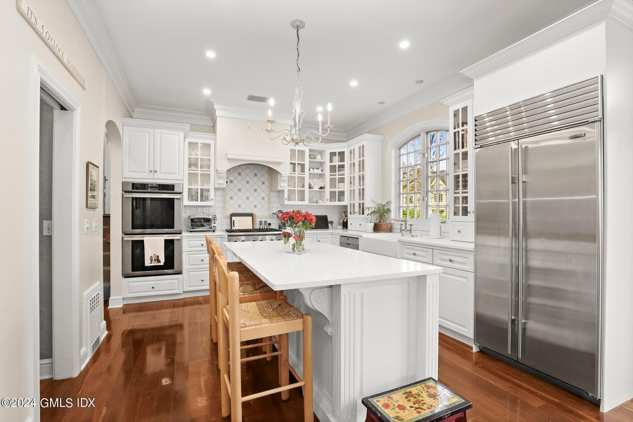 25 Field Road Riverside, CT 06878 - Photo 12 of 34 a kitchen with kitchen island white cabinets and refrigerator