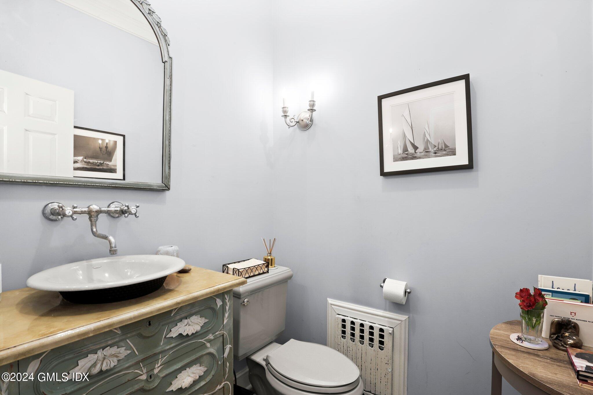 25 Field Road Riverside, CT 06878 - Photo 16 of 34 a bathroom with a toilet sink and mirror