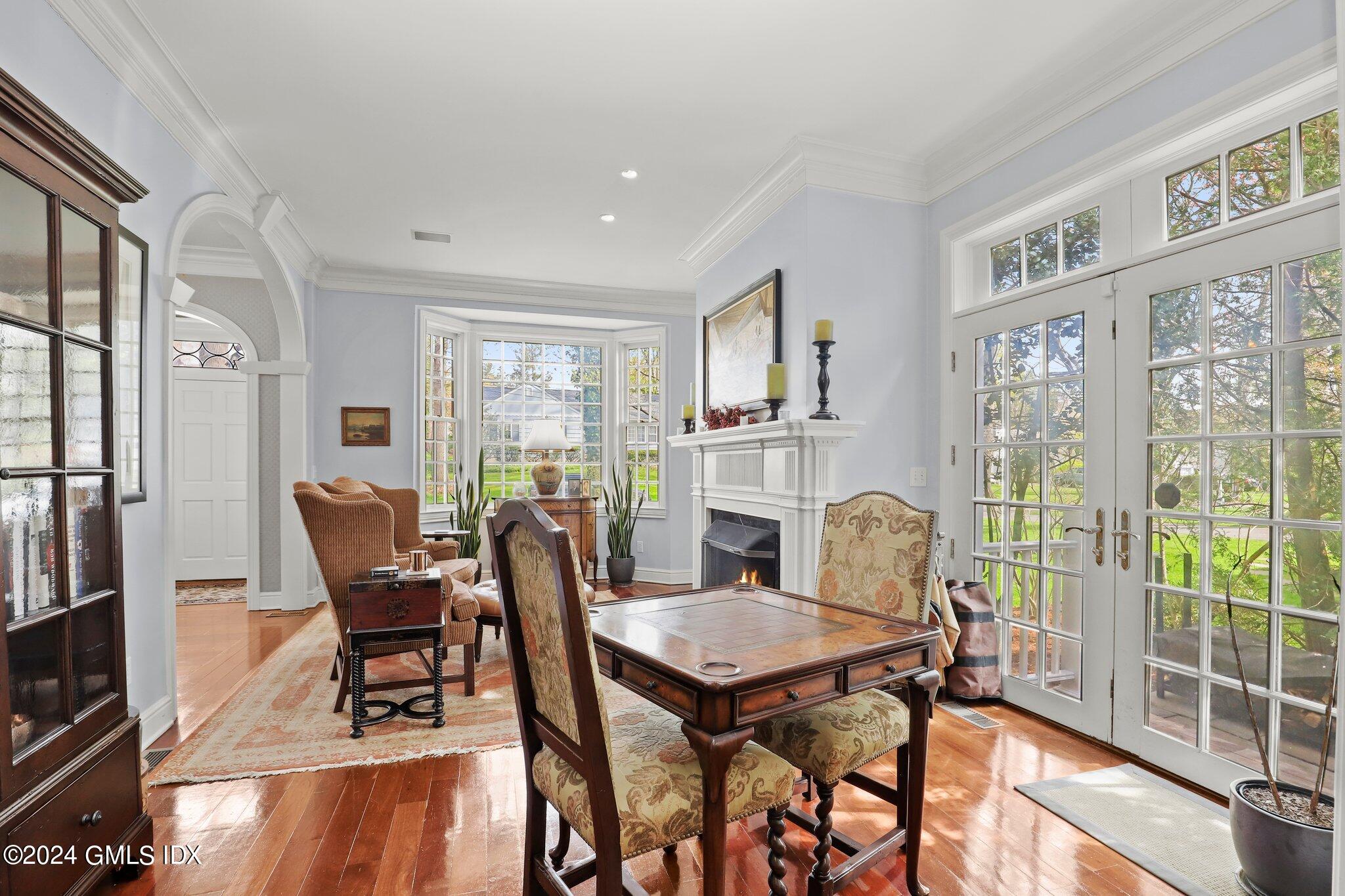 25 Field Road Riverside, CT 06878 - Photo 20 of 34 a dining room with furniture a fireplace and wooden floor