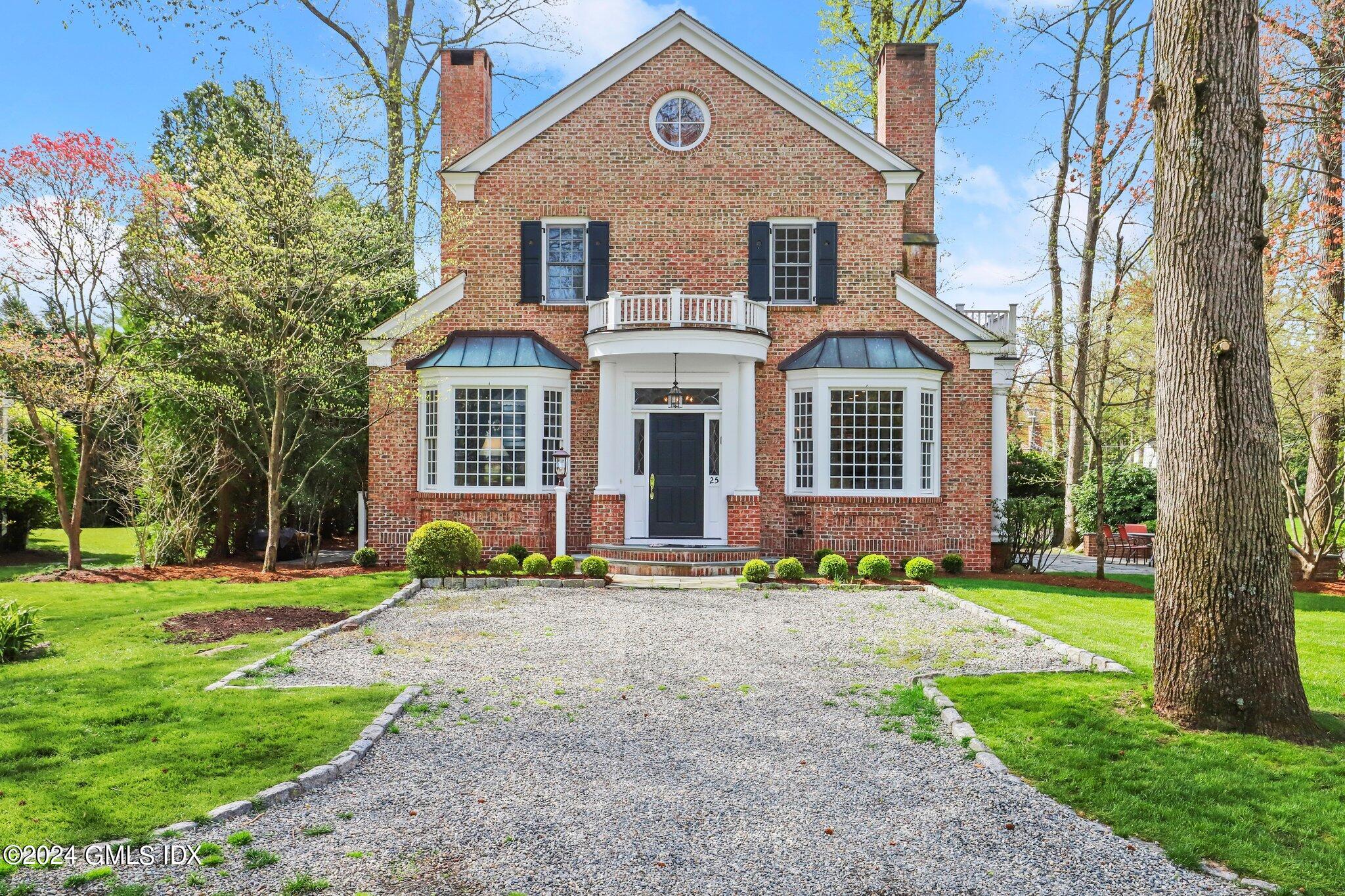 25 Field Road Riverside, CT 06878 - Photo 2 of 34 a front view of a house with a yard