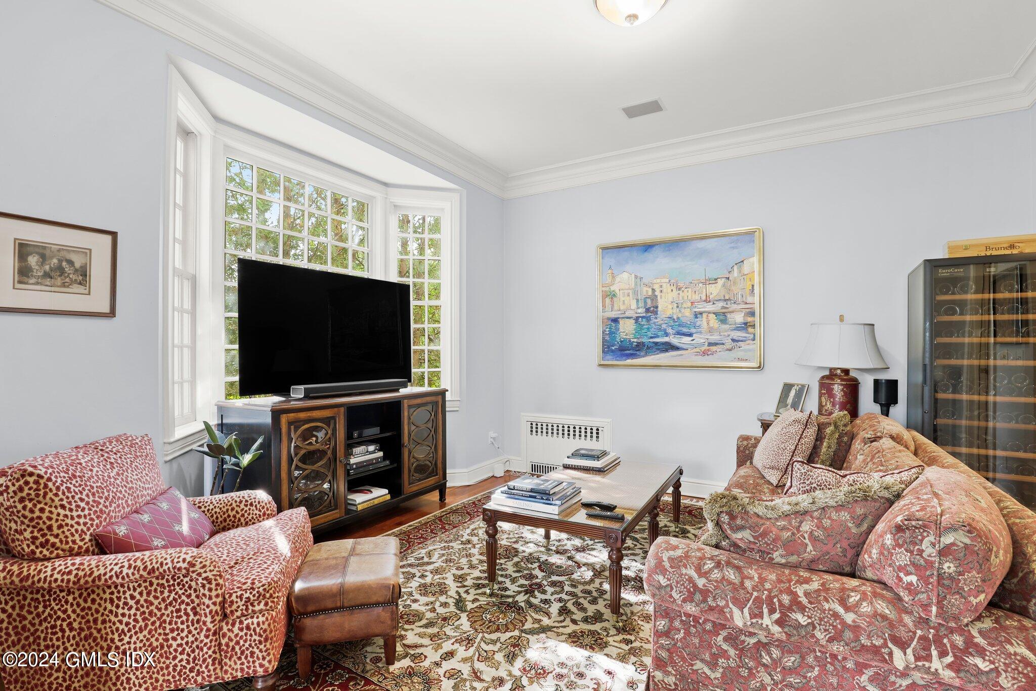 25 Field Road Riverside, CT 06878 - Photo 21 of 34 a living room with furniture and a flat screen tv