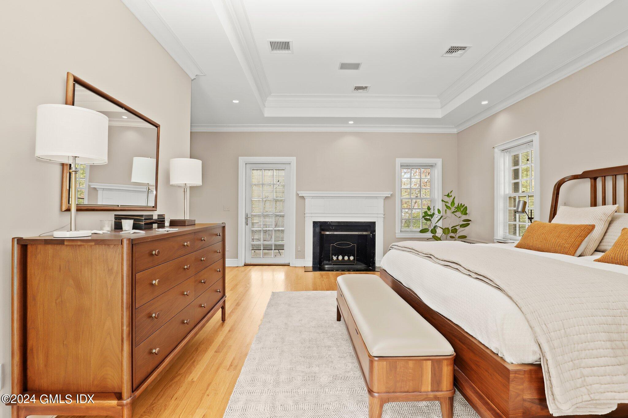 25 Field Road Riverside, CT 06878 - Photo 28 of 34 a spacious bedroom with a bed and a fireplace