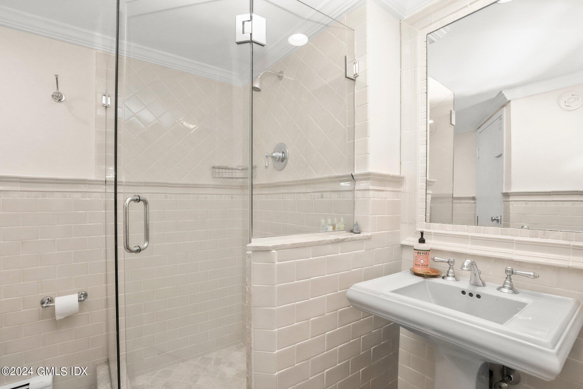 25 Field Road Riverside, CT 06878 - Photo 30 of 34 a bathroom with a sink shower and a mirror