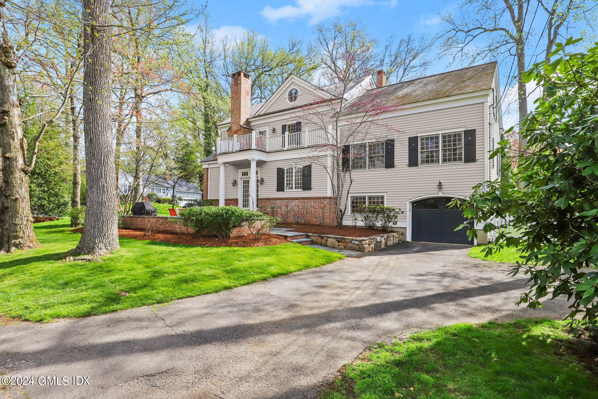 25 Field Road Riverside, CT 06878 - Photo 3 of 34 a front view of a house with a yard and trees