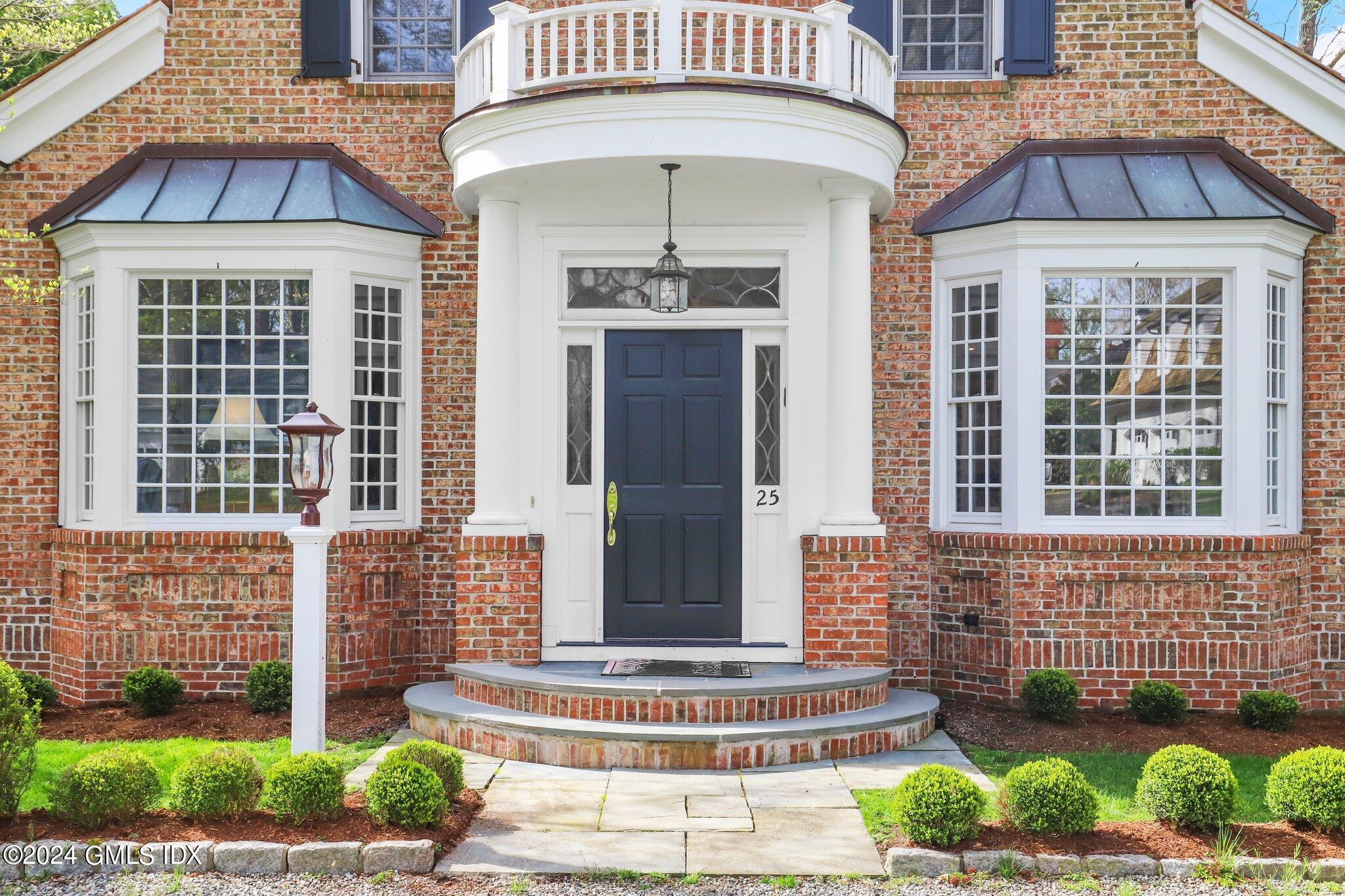 25 Field Road Riverside, CT 06878 - Photo 4 of 34 a front view of a house with a yard
