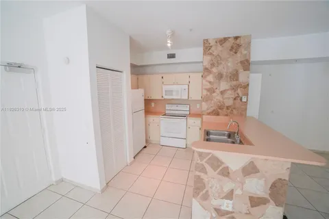 a white refrigerator freezer sitting inside of a kitchen