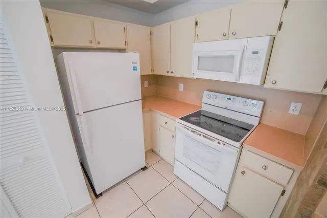 a utility room with sink dryer and washer