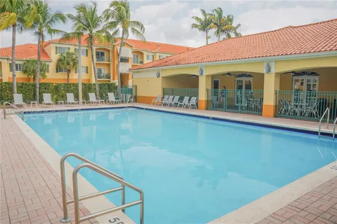 a view of a white building with a swimming pool