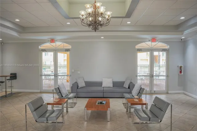 a living room with furniture and a chandelier