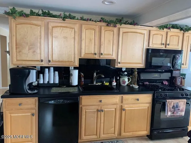 a kitchen with stainless steel appliances granite countertop a stove and a microwave