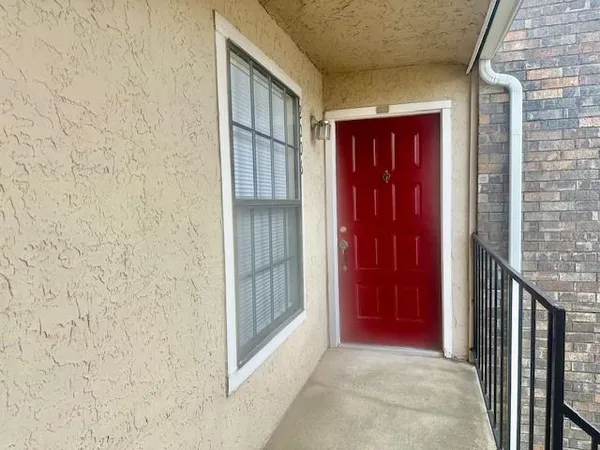 an empty room with windows and fireplace