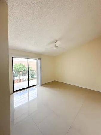 an empty room with a empty space and windows