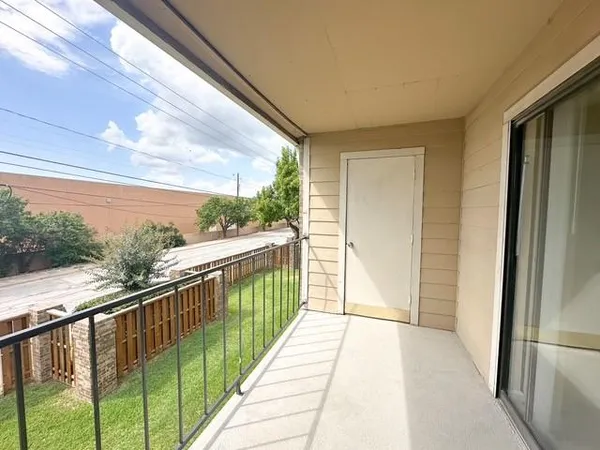 a balcony with view of outdoor space