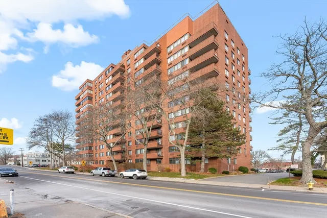 a view of a tall building next to a road