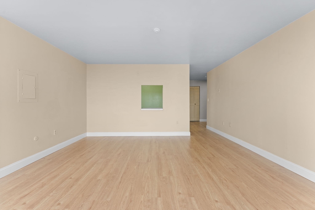 77 Adams Street, Unit 610 Quincy, MA 02169 - Photo 11 of 32 a view of an empty room with wooden floor