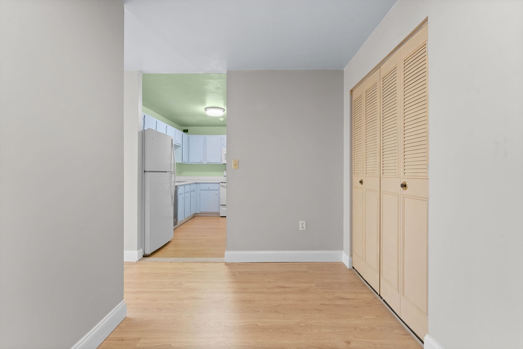 77 Adams Street, Unit 610 Quincy, MA 02169 - Photo 16 of 32 a view of a hallway with wooden floor and staircase