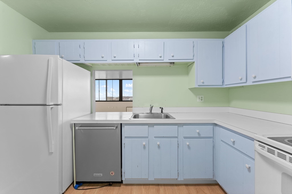 77 Adams Street, Unit 610 Quincy, MA 02169 - Photo 19 of 32 a kitchen with cabinets appliances and a sink