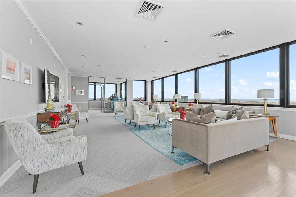 77 Adams Street, Unit 610 Quincy, MA 02169 - Photo 29 of 32 a living room with furniture and a large window