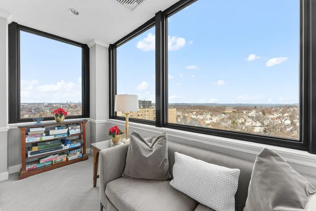 a living room with furniture and a floor to ceiling window
