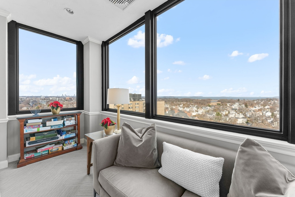 77 Adams Street, Unit 610 Quincy, MA 02169 - Photo 30 of 32 a living room with furniture and a floor to ceiling window