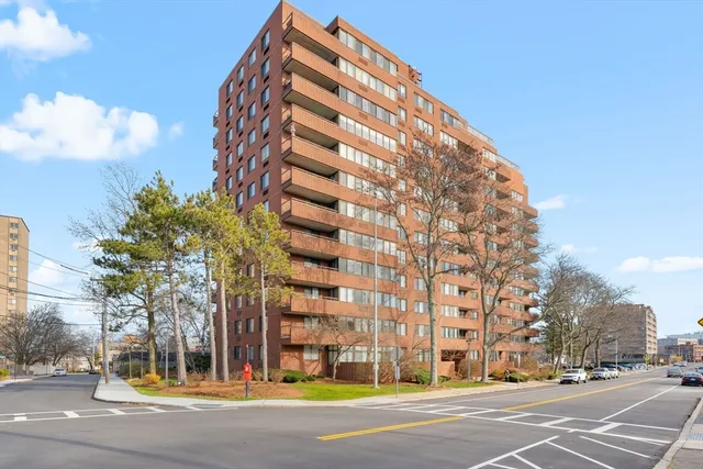 a view of a tall building next to a road