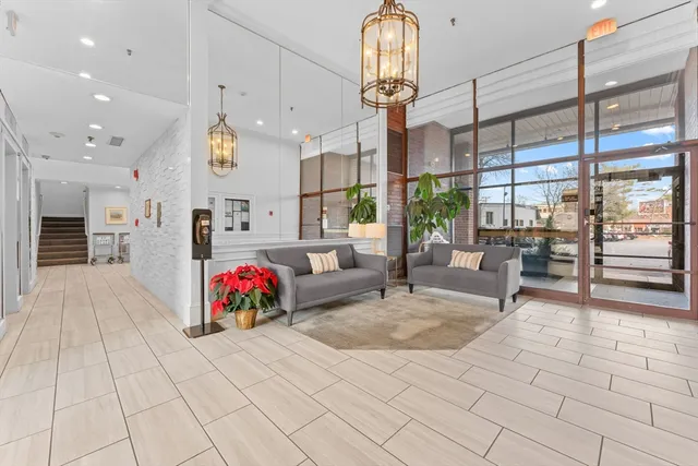a living room with fireplace furniture and a table