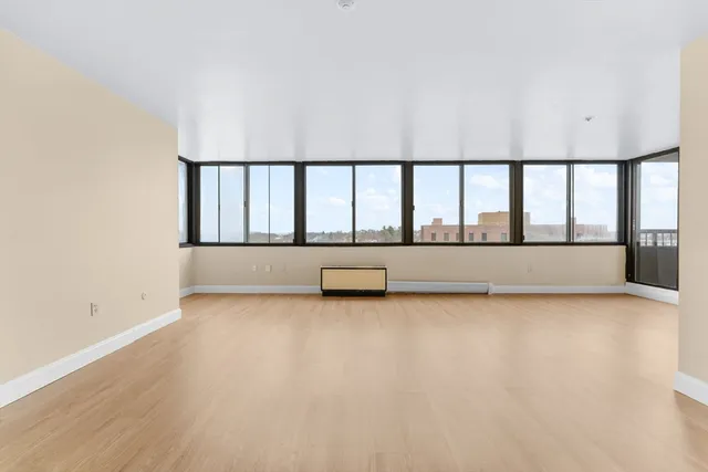 a view of a large room with wooden floor and a balcony