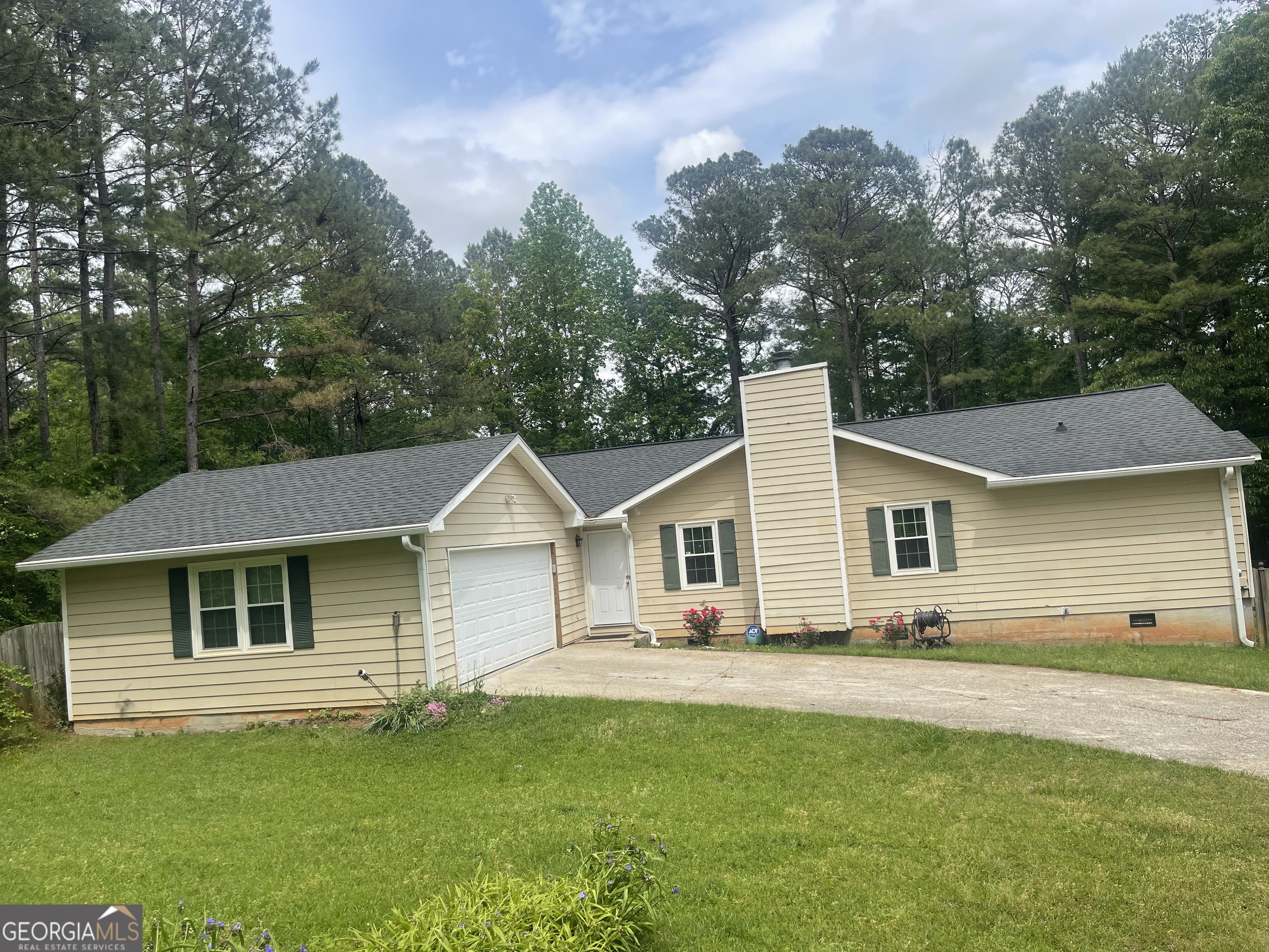 a front view of a house with a garden