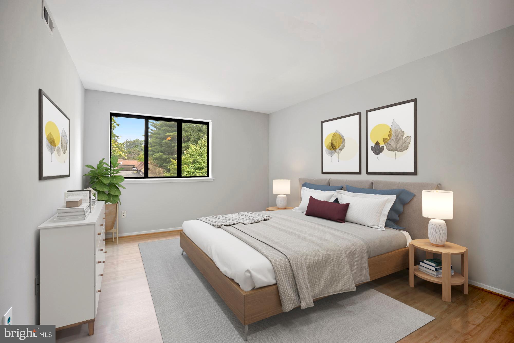 1645 Parkcrest Circle, Unit 200 Reston, VA 20190 - Photo 10 of 29 a bedroom with a bed and a flat screen tv