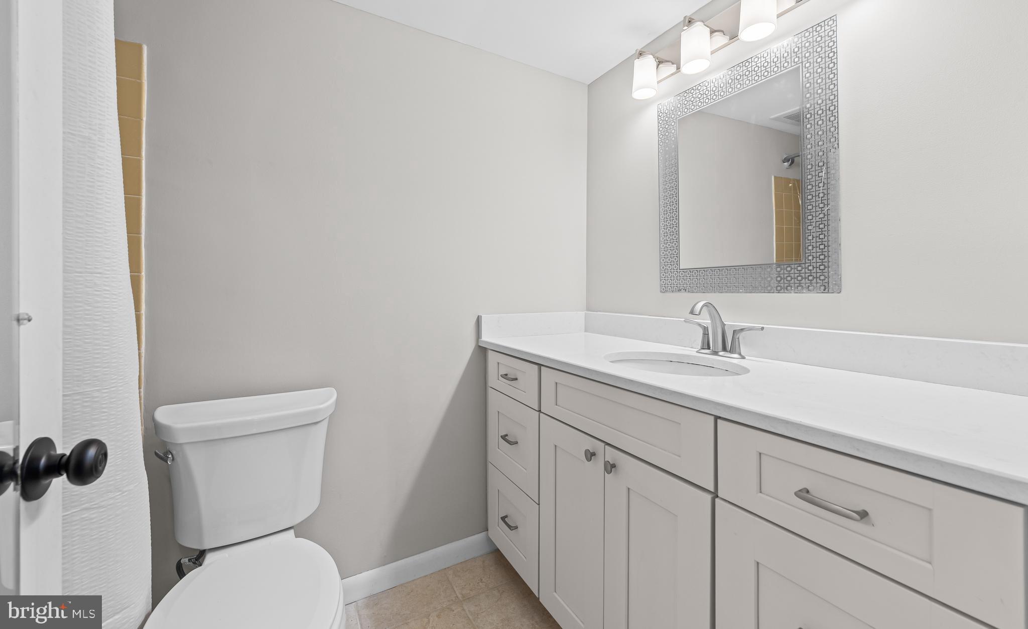 1645 Parkcrest Circle, Unit 200 Reston, VA 20190 - Photo 12 of 29 a bathroom with a toilet sink and mirror