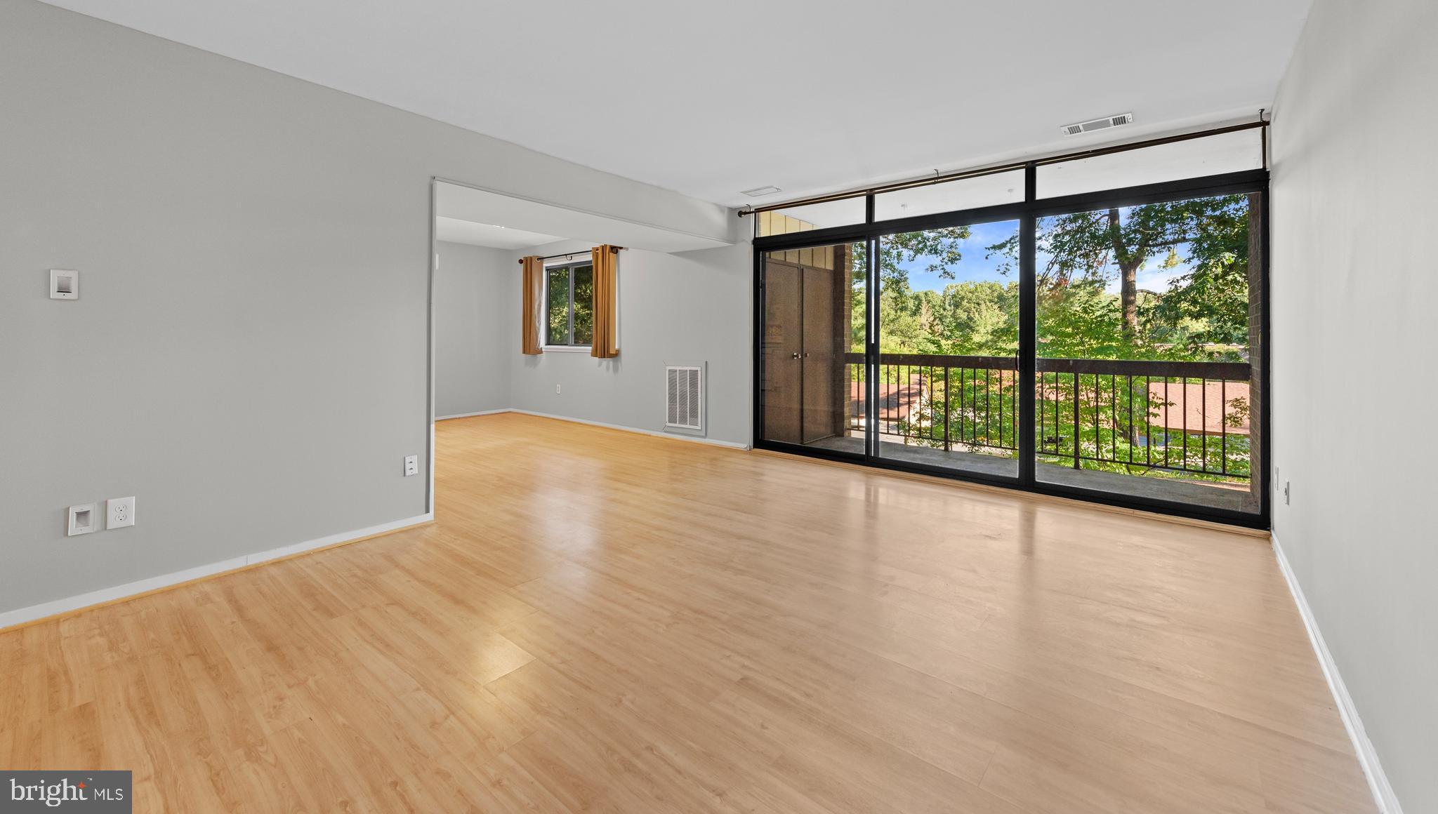 1645 Parkcrest Circle, Unit 200 Reston, VA 20190 - Photo 18 of 29 a view of an empty room with wooden floor and a window