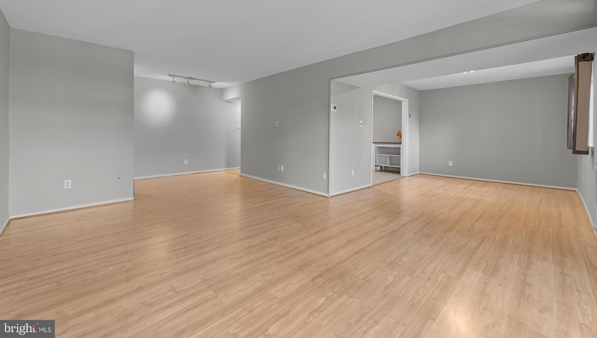 1645 Parkcrest Circle, Unit 200 Reston, VA 20190 - Photo 19 of 29 a view of an empty room with wooden floor and a window