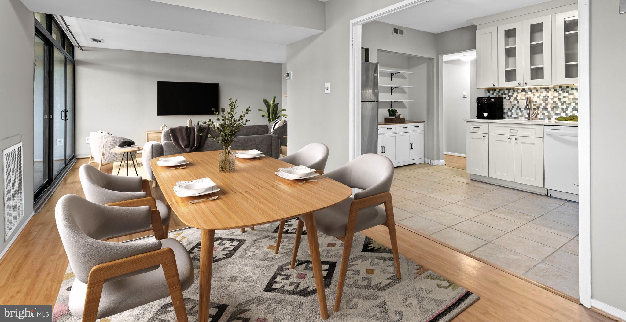 1645 Parkcrest Circle, Unit 200 Reston, VA 20190 - Photo 3 of 29 a view of a dining room with furniture and a flat screen tv