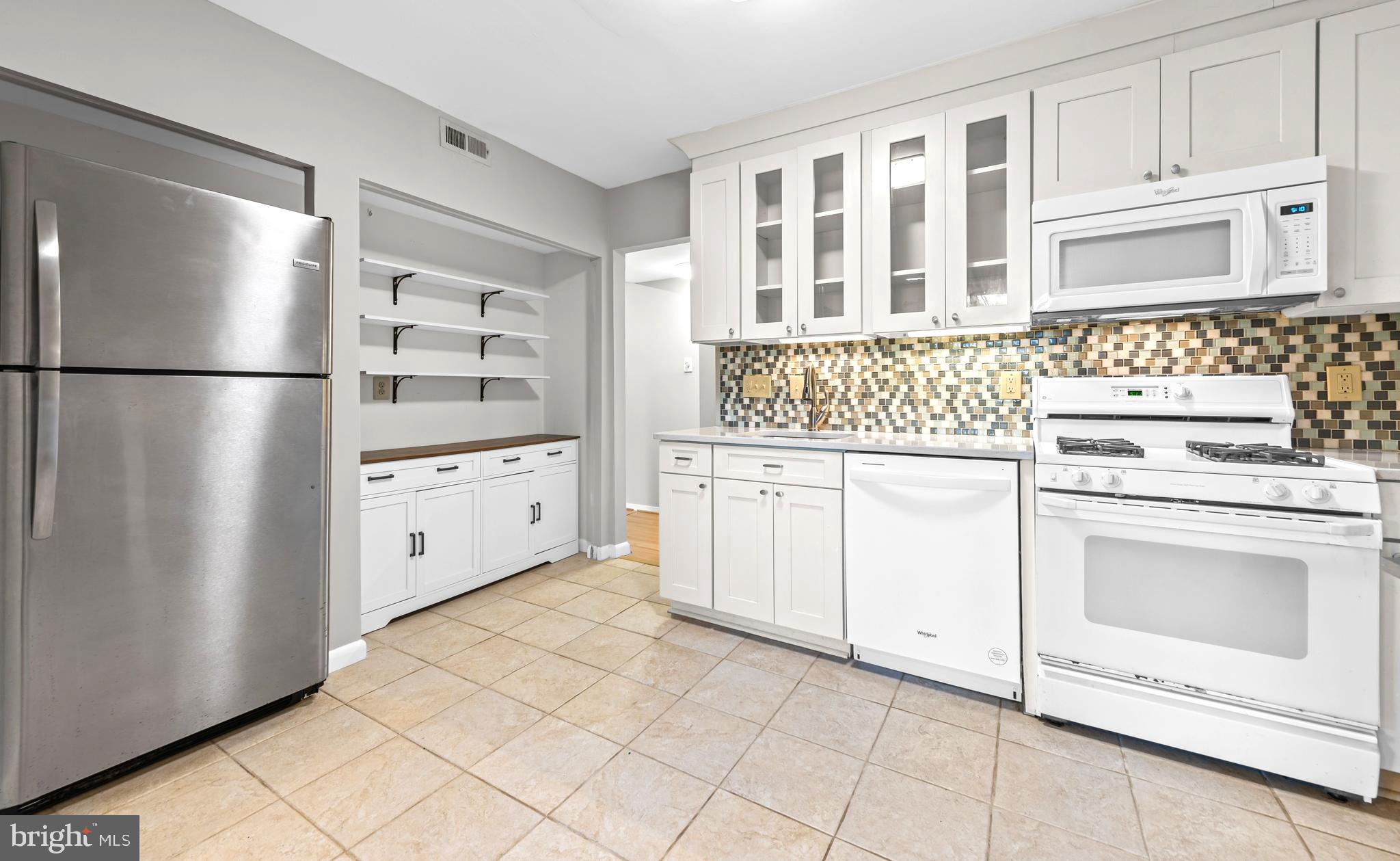 1645 Parkcrest Circle, Unit 200 Reston, VA 20190 - Photo 6 of 29 a kitchen with white cabinets and white appliances
