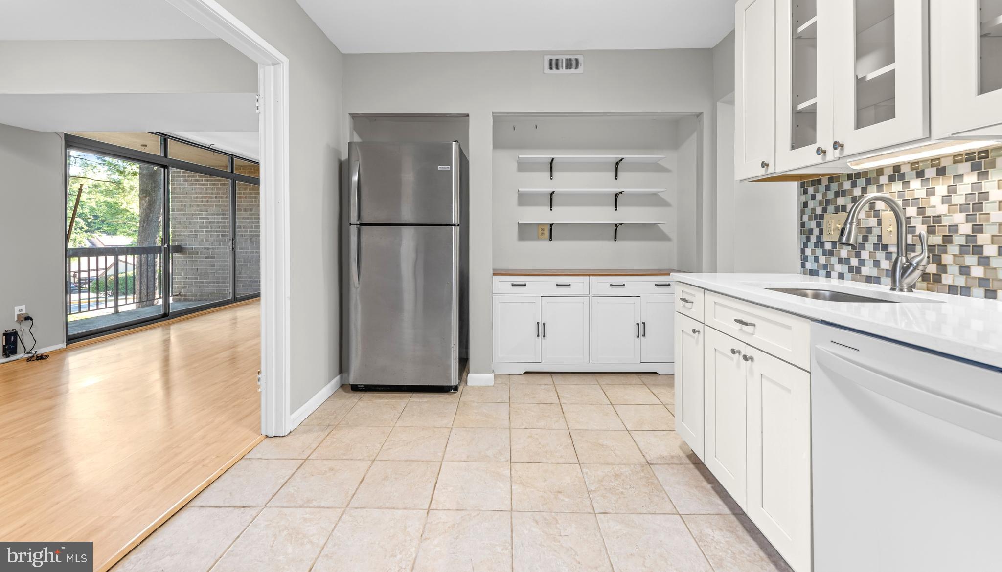 1645 Parkcrest Circle, Unit 200 Reston, VA 20190 - Photo 7 of 29 a kitchen with granite countertop a refrigerator and a sink