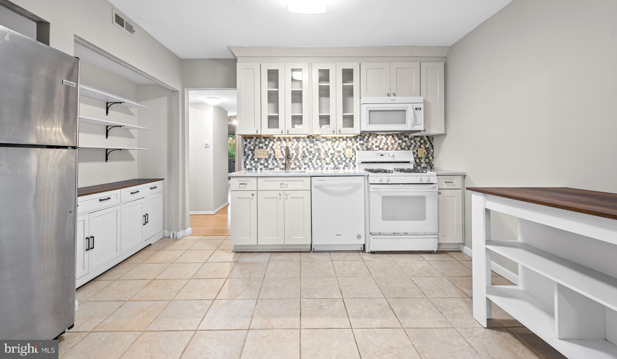 1645 Parkcrest Circle, Unit 200 Reston, VA 20190 - Photo 8 of 29 a kitchen with white cabinets and appliances