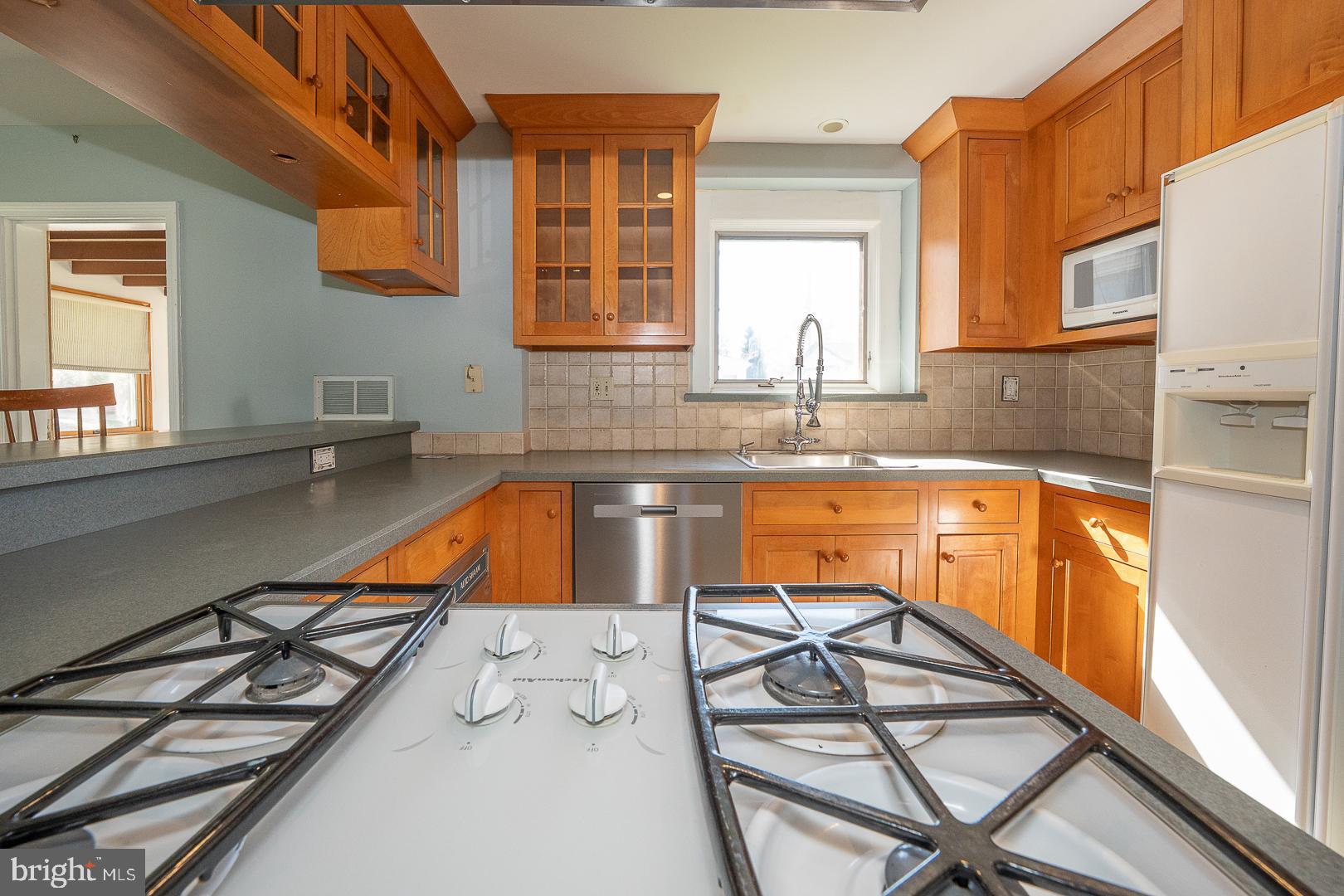 306 Sedgewood Road Springfield, PA 19064 - Photo 13 of 55 a kitchen with a sink a counter top space and cabinets
