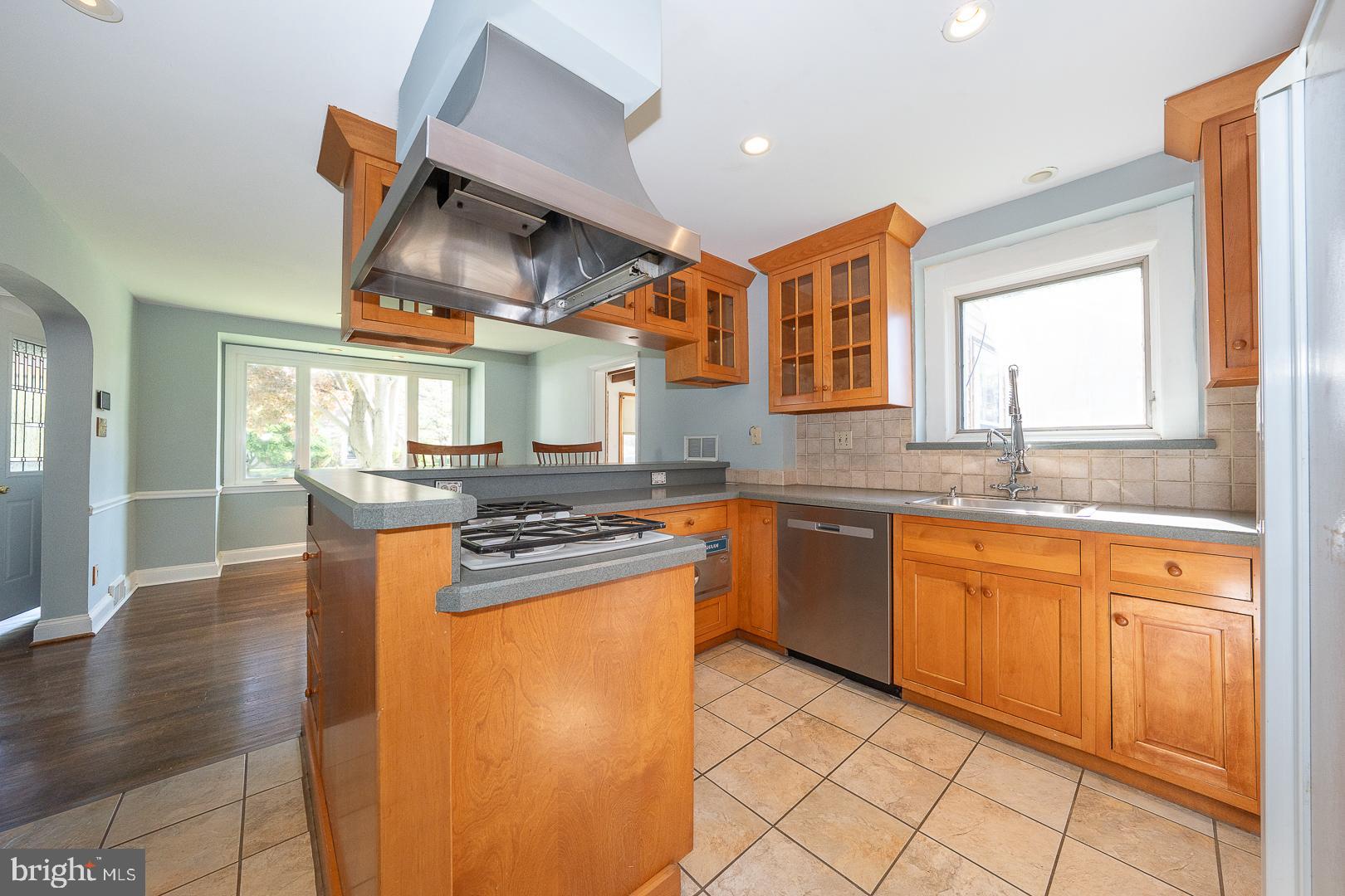 306 Sedgewood Road Springfield, PA 19064 - Photo 14 of 55 a kitchen with stainless steel appliances granite countertop a sink stove and refrigerator