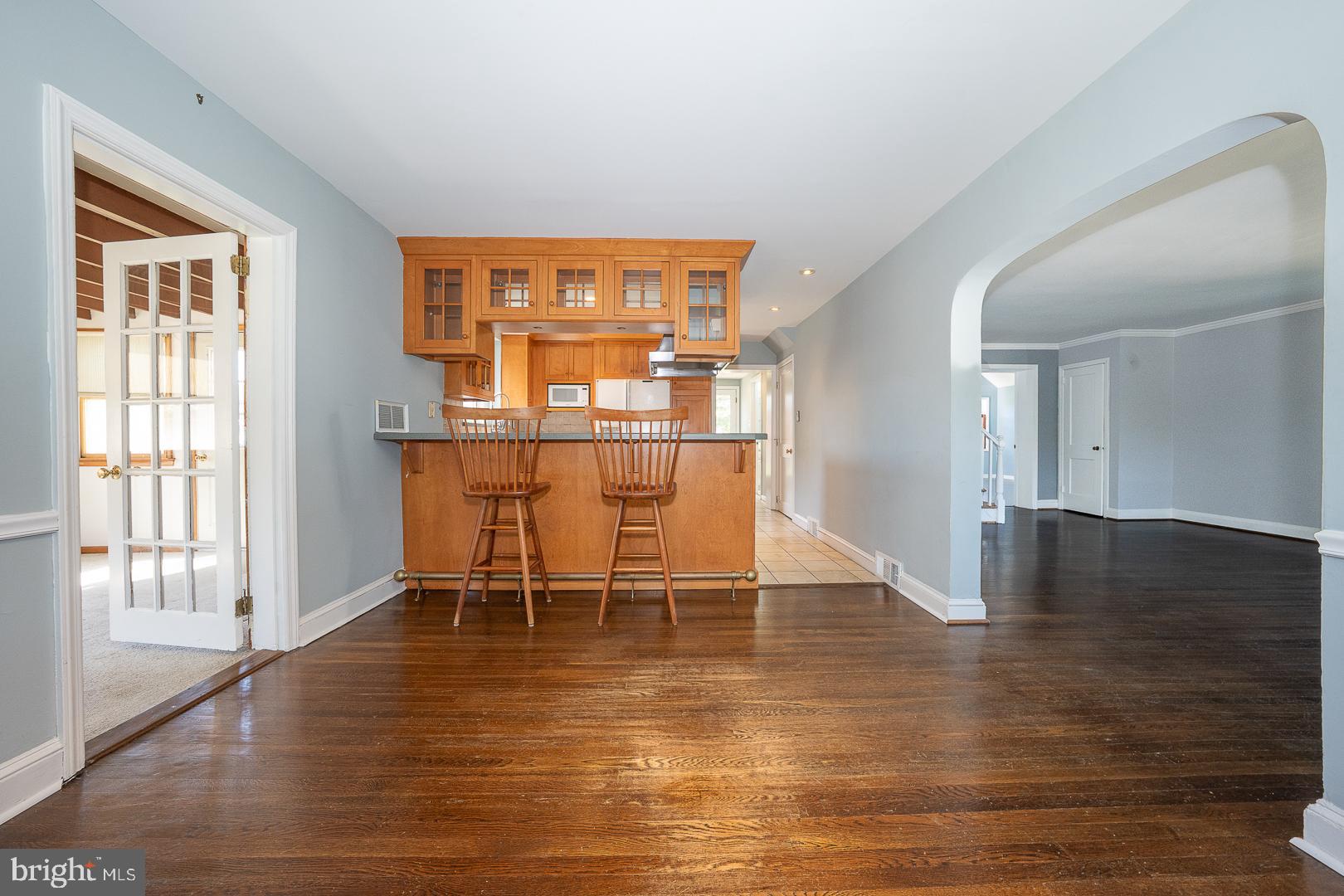306 Sedgewood Road Springfield, PA 19064 - Photo 15 of 55 a dining room with wooden floor a glass table and chairs