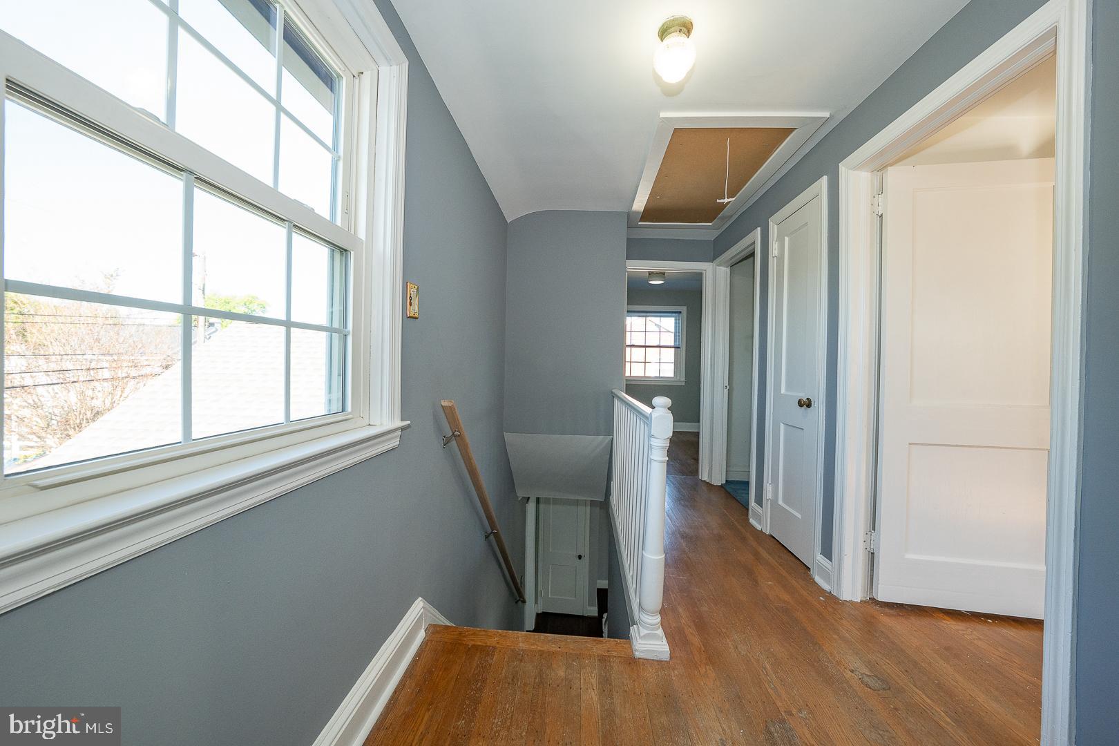 306 Sedgewood Road Springfield, PA 19064 - Photo 23 of 55 a view of a hallway with wooden floor and stairs