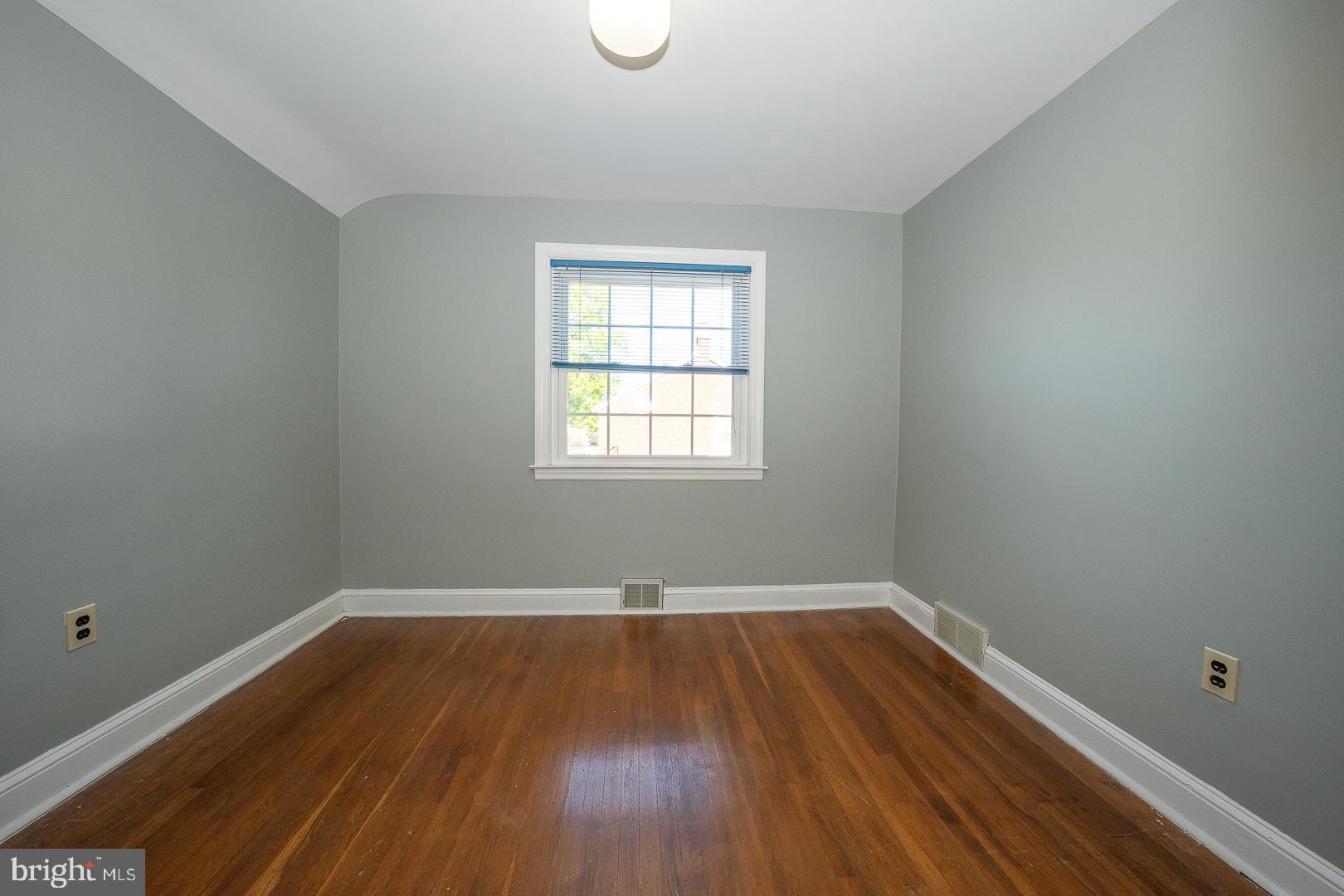 306 Sedgewood Road Springfield, PA 19064 - Photo 34 of 55 an empty room with wooden floor and windows