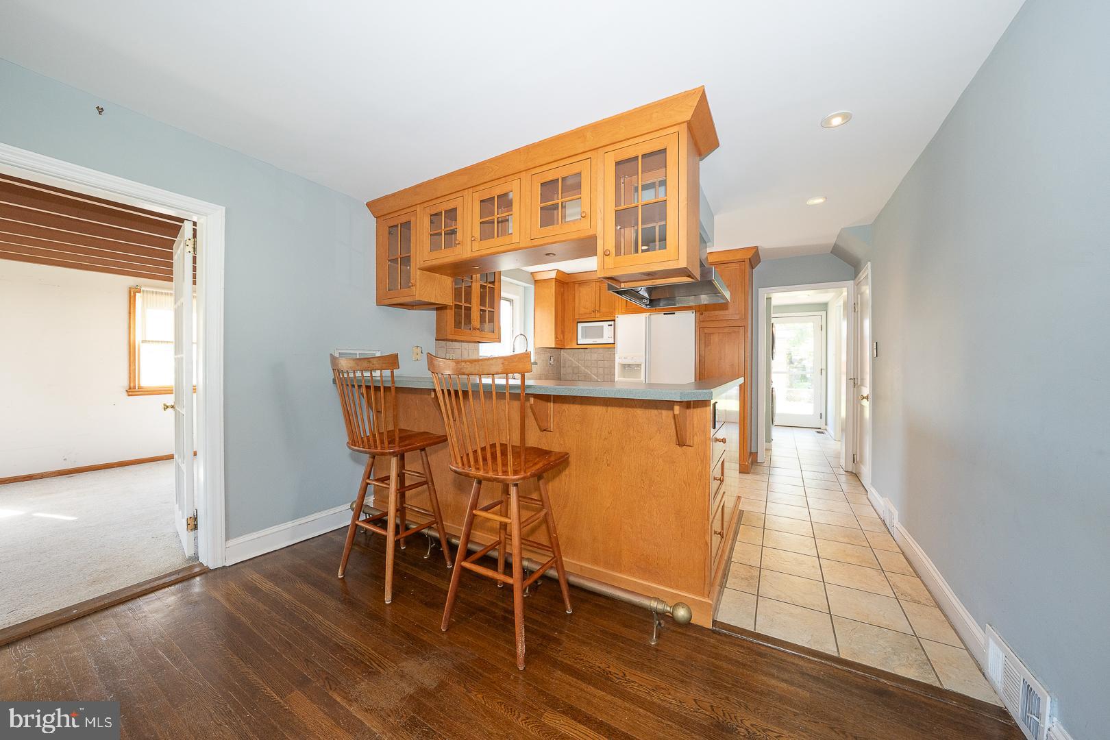 306 Sedgewood Road Springfield, PA 19064 - Photo 40 of 55 a dining room with furniture wooden floor a rug and a painting