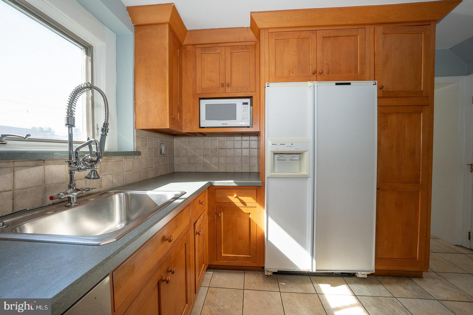 306 Sedgewood Road Springfield, PA 19064 - Photo 41 of 55 a kitchen with a refrigerator and a sink