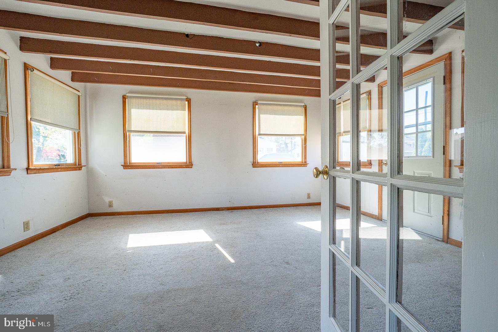 306 Sedgewood Road Springfield, PA 19064 - Photo 43 of 55 a view of an empty room with wooden floor and windows