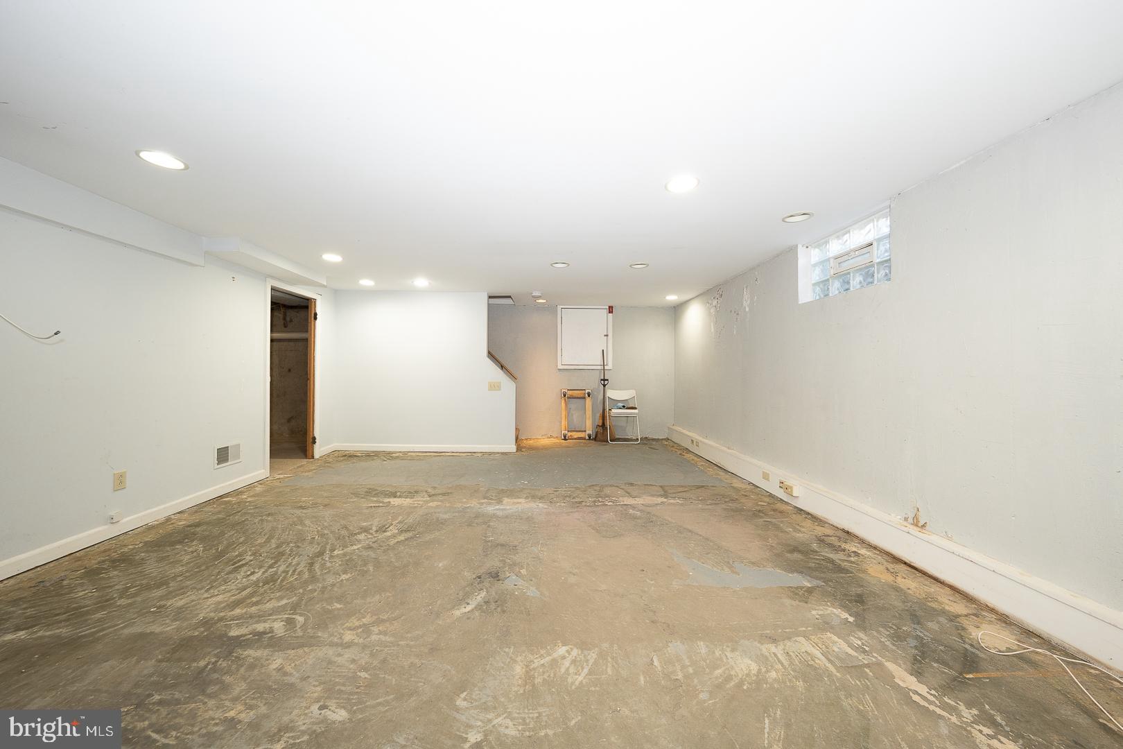 306 Sedgewood Road Springfield, PA 19064 - Photo 44 of 55 an empty room with a kitchen view and a refrigerator