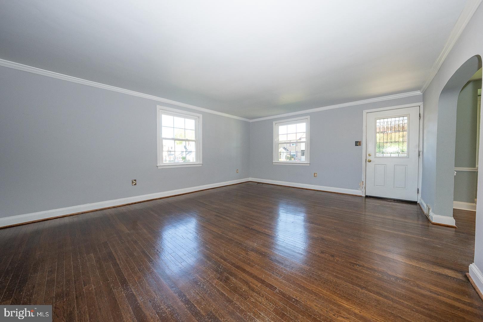 306 Sedgewood Road Springfield, PA 19064 - Photo 5 of 55 an empty room with wooden floor and windows